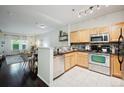 Bright kitchen featuring stainless steel appliances, modern cabinets, and sleek countertops at 2895 W Riverwalk Cir # 104, Littleton, CO 80123
