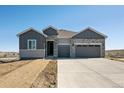 New construction home featuring stone and gray siding, a spacious driveway and a two-car garage at 13690 Emerald Lake St, Parker, CO 80138