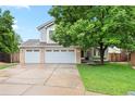 Lovely two-story home featuring a well-manicured lawn and charming curb appeal at 9756 Quay Loop, Broomfield, CO 80021