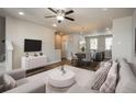 Open-concept living area with modern furnishings and stylish decor, seamlessly connecting to the dining area and kitchen at 630 E Hinsdale Ave, Littleton, CO 80122