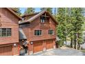 Exterior angle revealing the home's multi-car garage and additional exterior details at 960 Whispering Pines Ln, Breckenridge, CO 80424