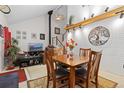 Bright dining room featuring a vaulted ceiling, stylish decor, and a staircase in the background at 19411 E Milan Cir, Aurora, CO 80013