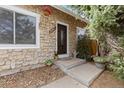 Welcoming front entrance with stone facade and steps leading to a decorative front door at 19411 E Milan Cir, Aurora, CO 80013