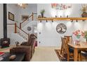 Cozy living room with a fireplace, adjacent to a dining area with decorative wall art at 19411 E Milan Cir, Aurora, CO 80013