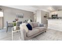 Bright living room featuring neutral tones, plush seating, and an open layout to the dining area at 555 E 10Th Ave # 206, Denver, CO 80203