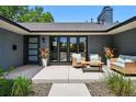 Inviting front porch with modern seating, decorative planters, and stylish entry door, perfect for outdoor relaxation at 3275 19Th St, Boulder, CO 80304