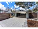 Home featuring a modern garage with sleek glass doors, a gray brick facade, and an expansive driveway at 3275 19Th St, Boulder, CO 80304