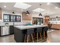 Bright, modern kitchen with a large island, marble countertops, pendant lighting and skylights at 3275 19Th St, Boulder, CO 80304