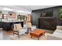 Open-concept living room with a cozy fireplace, modern furnishings, and seamless flow into the kitchen and dining area at 3275 19Th St, Boulder, CO 80304