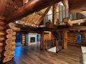 Spacious living area features a stone fireplace and soaring log beam vaulted ceiling at 733 Rainbow Rd, Idaho Springs, CO 80452