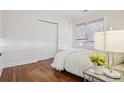 Cozy bedroom with hardwood floors, natural light from the window, and a comfortable bed at 1552 Hudson St, Denver, CO 80220
