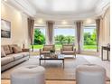 Bright living room with large windows offering beautiful views, plush seating, and stylish decor at 13 Buell Mansion Pkwy, Englewood, CO 80113