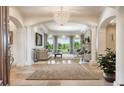 Bright living room featuring large windows, fireplace, and elegant chandelier at 13 Buell Mansion Pkwy, Englewood, CO 80113