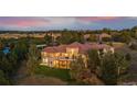 Expansive estate aerial view featuring lush landscaping, mature trees, and a sprawling lawn at 11541 Warrington Ct, Parker, CO 80138