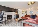 Inviting living room with fireplace, hardwood floors, and open concept kitchen at 7895 Allison Way # 203, Arvada, CO 80005