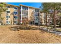 Exterior view of a condo building with well-maintained landscaping and a clear blue sky at 3022 S Wheeling Way # 109, Aurora, CO 80014