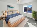 Virtually staged main bedroom with light wood furniture and blue blanket at 25643 E Bayaud Ave, Aurora, CO 80018