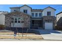Attractive two-story home featuring a stone and siding exterior, complemented by a well-manicured lawn at 2536 Wesley Ln, Lafayette, CO 80026