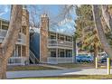 Building exterior showcasing a walkway and parking area at 8335 Fairmount Dr # 3-201, Denver, CO 80247