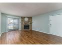 Living room features a fireplace and sliding glass door at 8335 Fairmount Dr # 3-201, Denver, CO 80247