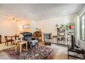 Inviting living room featuring neutral walls, a patterned rug, and comfortable seating at 1830 Newland Ct # 109, Lakewood, CO 80214