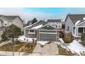 Beautiful home featuring a two-car garage, stone accents, and a well-maintained front lawn at 3906 S Quemoy Ct, Aurora, CO 80018