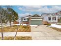 Charming single Gathering home featuring a two-car garage, stone accents, and a well-maintained front lawn at 3906 S Quemoy Ct, Aurora, CO 80018