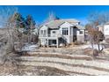 House with a backyard, deck, and stone retaining walls at 60 Golden Eagle Rd, Greenwood Village, CO 80121