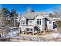 House with large backyard, deck, and stone retaining walls at 60 Golden Eagle Rd, Greenwood Village, CO 80121