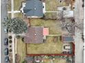 Overhead aerial view shows roof, fenced yard, landscaping, and nearby street at 4850 E 18Th Ave, Denver, CO 80220