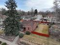 Aerial view of charming brick home, mature landscaping, and fenced yard at 4850 E 18Th Ave, Denver, CO 80220