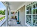 Inviting covered front porch with classic columns, seating, and view of the neighborhood at 2723 Galena St, Denver, CO 80238