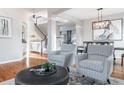 Inviting living space showcasing hardwood floors, a staircase, and an open layout at 9807 Arthur Ln, Highlands Ranch, CO 80130