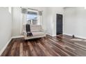 Bright living room showcasing hardwood floors, a comfortable sofa, and lots of natural light at 25123 E 5Th Ave, Aurora, CO 80018