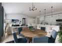 Open concept dining area with a round wooden table and blue chairs at 2165 Grayside Cir, Castle Rock, CO 80109