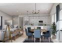 Open concept dining area with a round wooden table and blue chairs at 2165 Grayside Cir, Castle Rock, CO 80109