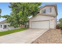 Two-story home with attached garage and front lawn, complemented by mature shade tree at 21767 Silver Meadow Ln, Parker, CO 80138