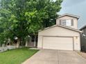 Inviting two-story house with a well-manicured lawn and a large tree in the front at 21767 Silver Meadow Ln, Parker, CO 80138