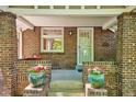 Inviting brick front porch with decorative potted plants and classic architectural details at 2683 Bellaire St, Denver, CO 80207