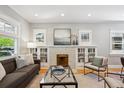 Bright living room with decorative fireplace and built-in shelving, perfect for relaxing or entertaining at 2683 Bellaire St, Denver, CO 80207