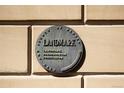 Close-up of a Landmark plaque on the building's exterior, signifying historical preservation at 3147 Umatilla St, Denver, CO 80211
