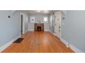Light-filled living room with hardwood floors, fireplace, and built-in bookshelves at 2921 N Fillmore St, Denver, CO 80205