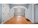 Bright living room features hardwood floors, arched entryway and natural light at 2921 N Fillmore St, Denver, CO 80205