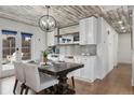 Elegant dining area featuring wainscoting, built-in cabinets, and designer light fixture at 11542 W 67Th Way, Arvada, CO 80004