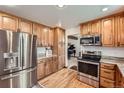 Modern kitchen featuring stainless steel appliances, granite countertops, and ample cabinet space at 5157 S Sedalia Ct, Centennial, CO 80015