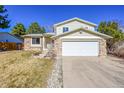 Two-story home featuring an attached garage and a well-manicured front yard at 15017 E Greenwood Pl, Aurora, CO 80014