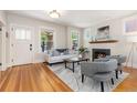 Bright living room with a decorative fireplace, hardwood floors, and large windows at 1121 S Ogden St, Denver, CO 80210