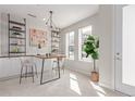 Bright office space features built-in shelves, stylish lighting, and natural light from large windows at 2436 Welton St, Denver, CO 80205