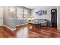 Living area with hardwood floors, gray walls, and a comfy couch at 3914 S Perth St, Aurora, CO 80013