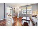 Bright living room with hardwood floors, large windows, and a view to another room at 3914 S Perth St, Aurora, CO 80013